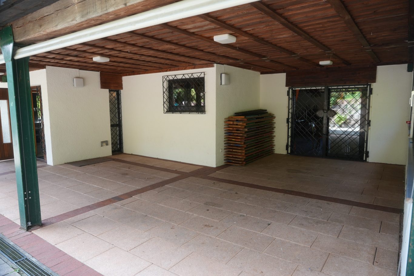 überdachte Terrasse, im Hintergrund Tür zu Gastraum